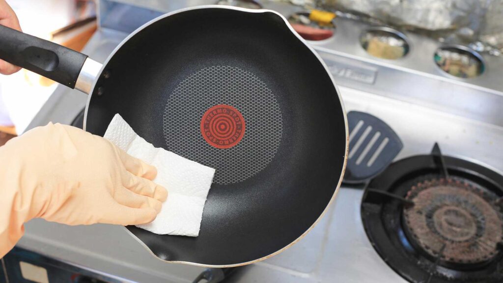 Wiping it with a paper towel is how to clean and season a cast iron skillet.