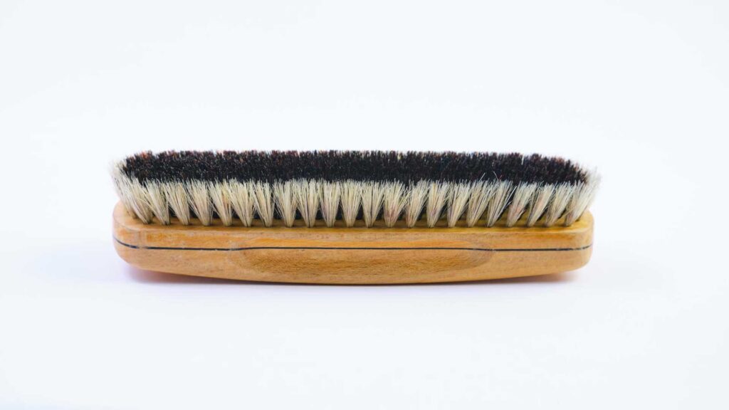 Soft bristle brush to clean cowboy felt hat.